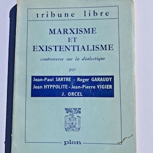 May include: A blue book with the title "Marxism et Existentialisme" and the text "controverse sur la dialectique" by Jean-Paul Sartre, Roger Garaudy, Jean Hyppolite, Jean-Pierre Vigier, and J. Orcel. The book is published by Plon.