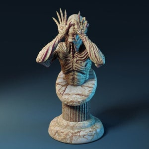 May include: A detailed bust sculpture of a pale, humanoid figure with a skeletal appearance. The figure has its hands raised to its face, covering its eyes. The sculpture is mounted on a white marble pedestal.