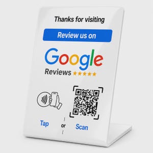 May include: A white acrylic sign featuring the text Thanks for visiting and Review us on Google Reviews with five gold stars. Below, a graphic shows a hand holding a phone near a contactless symbol and a QR code with the text Tap or Scan.