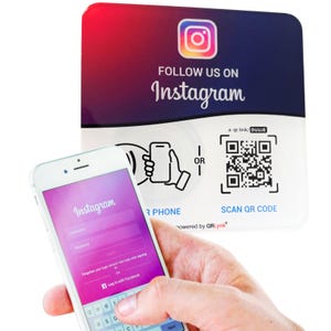 May include: A square sign with a red-to-blue gradient background featuring the Instagram logo and the text FOLLOW US ON Instagram. It includes a QR code, a graphic showing a phone, and the text SCAN QR CODE, powered by QRLynk.