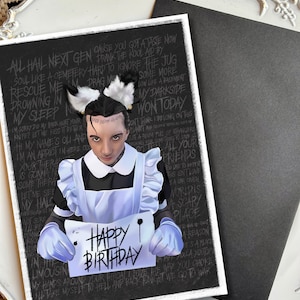 May include: A black and white birthday card featuring a person in a maid's outfit holding a sign that reads "Happy Birthday". The card has a black background with white text, including song lyrics.