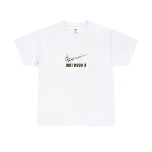 May include: White t-shirt with a green marijuana leaf design in the shape of the Nike swoosh logo and the text "JUST DOOB IT" underneath.