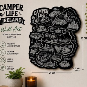 Może przedstawiać: Czarna, grawerowana laserowo grafika ścienna z akrylu w kształcie Irlandii, z mapą miast i zabytków. Tekst "Camper Life Ireland" znajduje się na górze. Grafika ma 24 cm szerokości, 26 cm wysokości i 5 mm grubości.