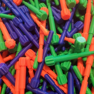 May include: A pile of colorful plastic rods with rounded ends. The rods are blue, green, and orange.