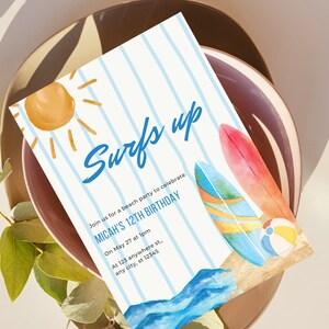 May include: A blue and white striped invitation with the text "Surfs Up" in blue. The invitation is for Micah's 12th birthday beach party. The invitation features a sun, surfboards, and waves.