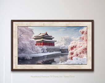 May include: A framed print of a traditional Chinese building with red walls and a golden roof, surrounded by snow-covered trees and a frozen lake. The print has a white and brown frame.