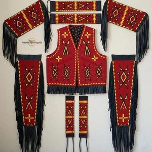 May include: A red vest with black fringe and geometric patterns in yellow and black, accompanied by matching arm cuffs and leg wraps featuring similar designs. The set includes a logo with the text NativeEagleRegalia on the upper left side.