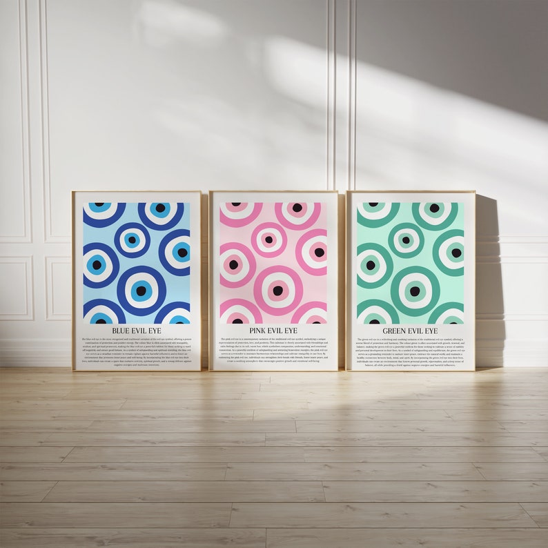 May include: Three framed prints with a pattern of blue, pink, and green evil eyes. Each print has a title: "Blue Evil Eye", "Pink Evil Eye", and "Green Evil Eye".