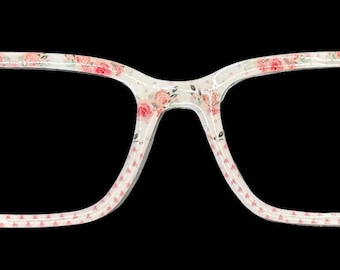 May include: Eyeglasses with a white frame featuring a delicate floral pattern in pink and red. The rectangular frames have a subtle dotted border, offering a stylish and feminine aesthetic. The glasses are set against a black background.