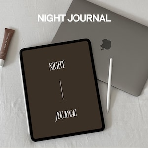 May include: A brown iPad with the words "NIGHT JOURNAL" on the screen. The iPad is on a white surface with a silver laptop and a white stylus.