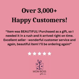May include: A pink background with the text "Over 3,000+ Happy Customers!" and a customer review that reads "Item was BEAUTIFUL! Purchased as a gift, so I needed it in a rush and it arrived right on time. Excellent seller - wonderful customer service and again, beautiful item! I'll be ordering again!"  Five stars are displayed below the review. The text "MOM BOSS gifts co." is displayed below the stars with a gift box icon.