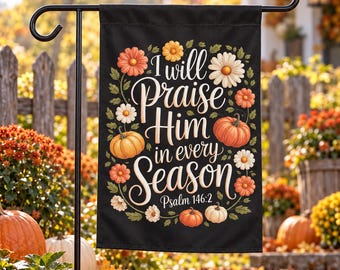 May include: A black rectangular garden flag featuring the white text I will Praise Him in every Season Psalm 146:2. The design is surrounded by a wreath of orange, yellow, and white flowers, green leaves, and small orange and white pumpkins.