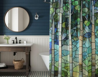 May include: A shower curtain with a stained-glass tree design in shades of green, blue, and white. The curtain features a stylized forest scene with leaves and branches. The bathroom has a dark blue wall, a round mirror, and a white bathtub.