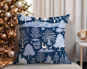 May include: A blue throw pillow with a white pattern of trees, birds, and a deer. The pattern is repeated throughout the pillow.