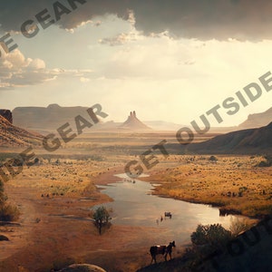 May include: A scenic view of a desert landscape with a winding river in the foreground. The river is surrounded by dry, brown grass and a few trees. In the distance, there are tall, red rock formations. The sky is a hazy blue with a few clouds.