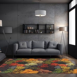 May include: A colorful area rug with a vibrant pattern of orange, red, green, and yellow hues. The rug is placed in a modern living room setting, beneath a gray sofa and in front of a concrete wall. The rug adds a pop of color to the room.