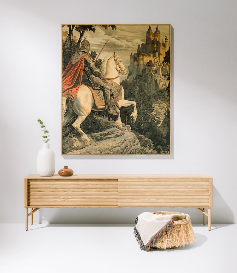 May include: A vintage tapestry featuring a knight riding a white horse towards a medieval castle. The tapestry is framed in a wooden frame and has a detailed background of trees and foliage.