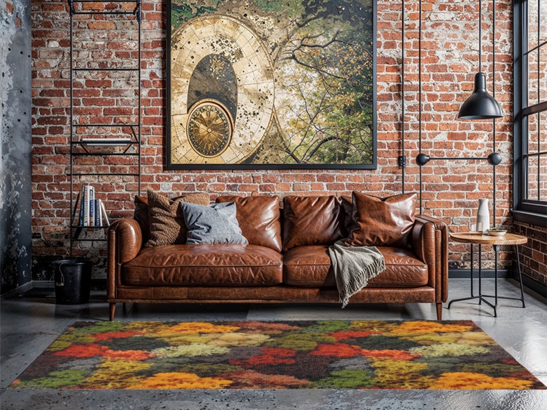 May include: A living room scene featuring a brown leather sofa, a colorful area rug with an abstract design, and a large framed artwork. The rug has a pattern of orange, yellow, green, and red hues. The room has exposed brick walls and a modern industrial aesthetic.