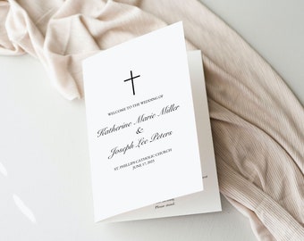 Peut inclure: Un programme de mariage blanc avec une croix noire en haut. Le texte indique "Bienvenue au mariage de Katherine Marie Miller & Joseph Lee Peters. Église catholique St. Phillips. 17 juin 2023."