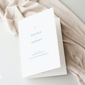 May include: A white wedding program with a cross at the top and the names Maura and Jeffrey in blue text. The text below reads "8.17.24 Order of Service St. Patrick's Church, Fishers, IN"