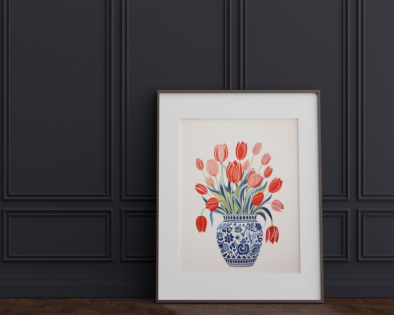 May include: A framed print of a watercolor painting featuring a bouquet of red and pink tulips in a blue and white porcelain vase with a floral pattern.