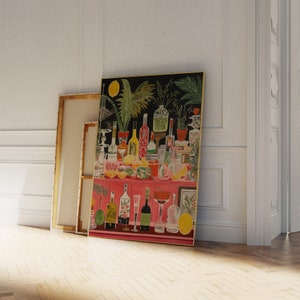 May include: A colorful painting of a still life featuring a variety of bottles, glasses, and fruit. The painting is set against a dark background and features a pink countertop. The painting is framed in gold.
