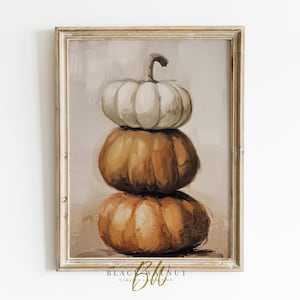 May include: A framed painting of three pumpkins stacked on top of each other. The top pumpkin is white, the middle pumpkin is orange, and the bottom pumpkin is a darker orange. The pumpkins are painted in a realistic style.