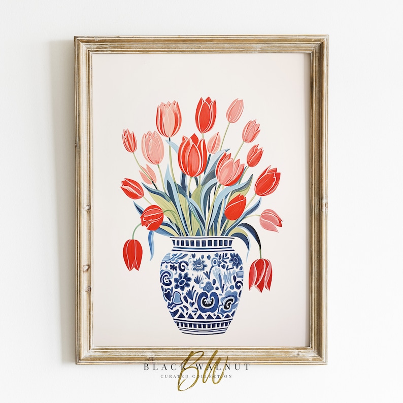 May include: A bouquet of red and pink tulips in a blue and white porcelain vase with a floral pattern. The vase is sitting on a white background.