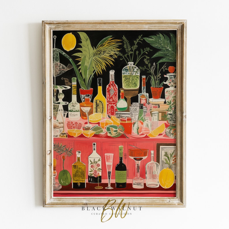 May include: A framed illustration of a bar scene with a pink countertop, various bottles of liquor, glasses, and fruit. The background is black with green plants and a lemon.