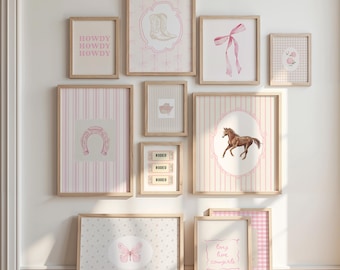 May include: A collection of framed art prints with a cowgirl theme. The prints feature images of a horseshoe, cowboy boots, a horse, a butterfly, and the words "Howdy" and "Long live cowgirls." The color palette includes pink, white, and tan.