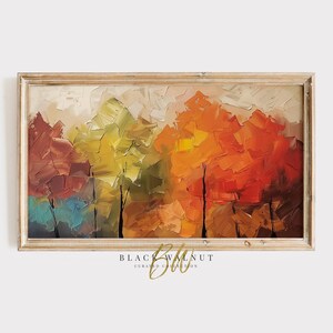 Puede incluir: Una pintura abstracta enmarcada que representa una escena de bosque con árboles en tonos de rojo, naranja, amarillo y verde. La pintura tiene un efecto texturizado, de pinceladas.