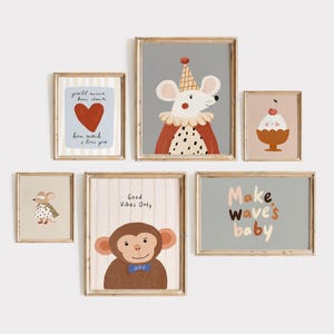 May include: A collection of framed art prints featuring whimsical animal illustrations and positive affirmations. The prints include a mouse in a circus outfit, a monkey with a bow tie, and the text "Make wave's baby". The color palette includes soft pastels.