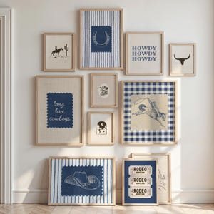 May include: A collection of framed art prints with a Western theme. The prints feature images of a cowboy on a horse, a horseshoe, a cowboy hat, a bull skull, and the text "HOWDY HOWDY HOWDY" and "long live cowboys". The color palette includes shades of blue, beige, and brown.