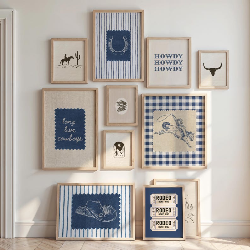 May include: A collection of framed art prints with a Western theme. The prints feature images of a cowboy on a horse, a horseshoe, a cowboy hat, a bull skull, and the text "HOWDY HOWDY HOWDY" and "long live cowboys". The color palette includes shades of blue, beige, and brown.