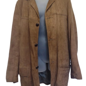 May include: A brown suede jacket with a collared neckline and three dark buttons. The jacket has two front pockets and a tailored fit. The garment is displayed on a mannequin.