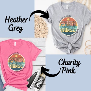 May include: Two t-shirts with a retro-style graphic design. The design features a sun, a rainbow, and the text "Summer Camp Nurse" with the words "Protector of Health" and "Guardian of Giggles" surrounding the design. The t-shirt on the left is pink and the t-shirt on the right is heather grey.