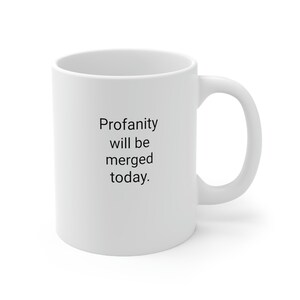 Może przedstawiać: Biały ceramiczny kubek do kawy z czarnym tekstem, który brzmi "Profanity will be merged today."