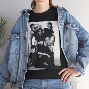 May include: Black and white photo of five people wearing black clothing. The photo is printed on a black t-shirt.