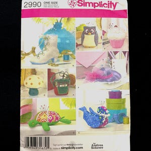 May include: Simplicity sewing pattern featuring various fabric crafts, including an owl, a cupcake, a mushroom, a turtle, and a hat. The pattern includes the text "ONE SIZE" and the Simplicity logo.