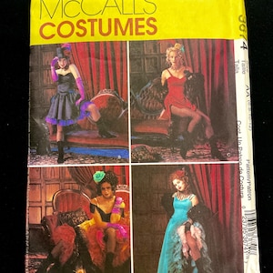 May include: McCall's Costumes sewing pattern for a saloon girl costume. The pattern includes four different costume options, each with a different dress, hat, and accessories. The pattern number is 3674 and the size is AA (6-8-10-12).