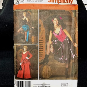 May include: Simplicity sewing pattern 2851 featuring costume designs. The package shows three women in different outfits, including a red dress, a black and pink dress, and a black and blue skirt. The text on the package includes the size range and the Simplicity logo.