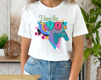 May include: White t-shirt with a graphic design featuring a roller skate, a video game controller, and the text "I love the 90's".