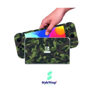 May include: A camouflage Nintendo Switch console skin with a green, brown and black pattern. The skin is designed to fit the Nintendo Switch console and Joy-Cons. The skin is made of high-quality vinyl and is easy to apply and remove.