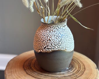 medium size hand made wheel thrown pottery vase made with dark brown chocolate clay with a cracked white crawling cobblestone glaze