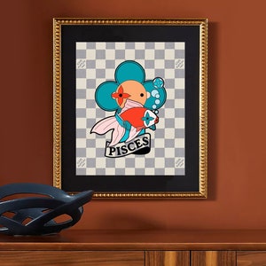 May include: A framed print with a white and brown checkered background. A blue flower with a red center and a pink fish with a red body and a Louis Vuitton logo is in the center of the print. The text "Pisces" is below the fish.