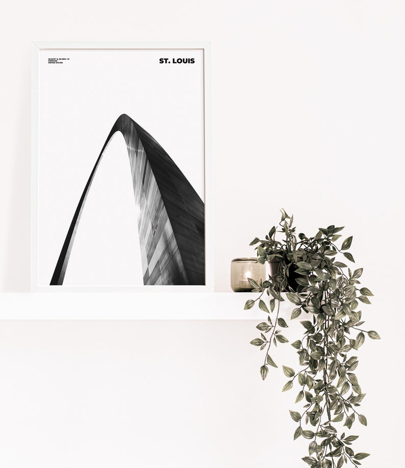 May include: A black and white photograph of the Gateway Arch in St. Louis, Missouri. The arch is a popular tourist destination and a symbol of the city.
