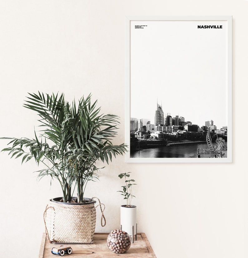May include: A black and white photograph of the Nashville skyline with the word "NASHVILLE" in white text at the top of the image.