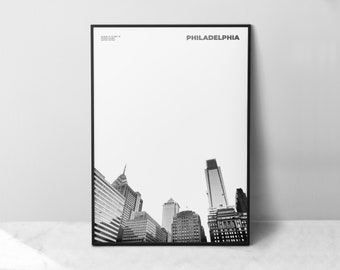 May include: Black and white photograph of the Philadelphia skyline. The image shows a low angle view of several skyscrapers, including the iconic Comcast Center.