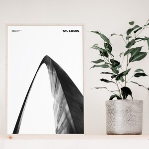 May include: Black and white photograph of the Gateway Arch in St. Louis, Missouri. The arch is a prominent landmark in the city and is a popular tourist destination.