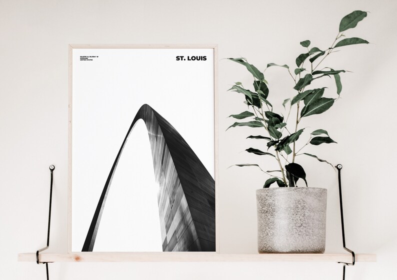 May include: Black and white photograph of the Gateway Arch in St. Louis, Missouri. The arch is a prominent landmark in the city and is a popular tourist destination.